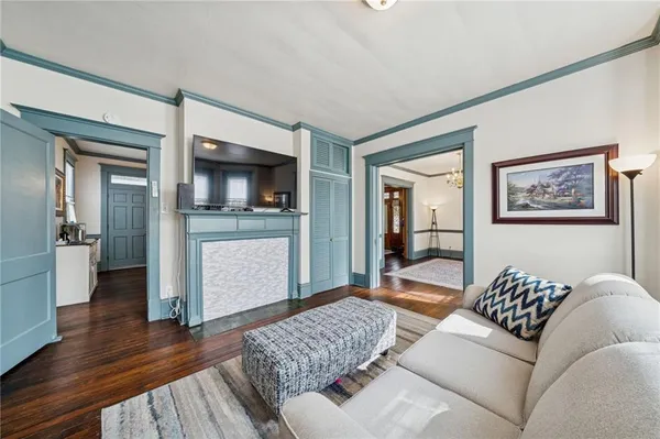 a living room with furniture and a wooden floor