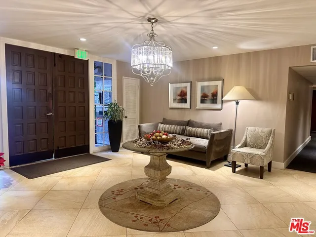 a living room with furniture and a chandelier