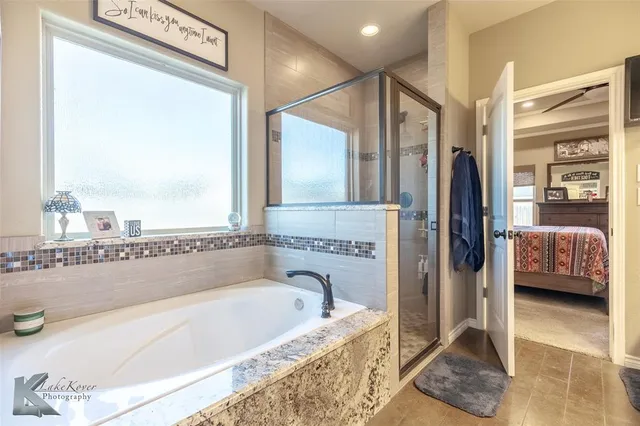 a bathroom with a tub and a shower