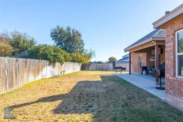 a swimming pool with yard and outdoor seating