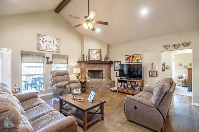 a living room with furniture a clock and a large window