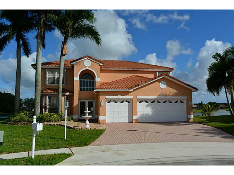 12656 Tucano Circle Boca Raton, FL 33428 - Photo 1 of 12 a front view of a house with a yard