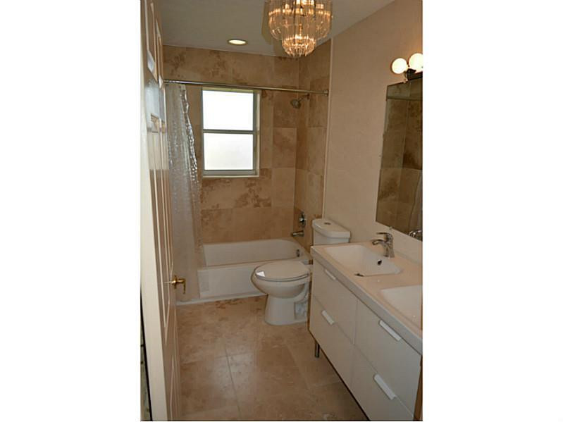 12656 Tucano Circle Boca Raton, FL 33428 - Photo 11 of 12 a spacious bathroom with a toilet a sink and mirror