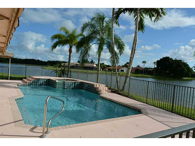 12656 Tucano Circle Boca Raton, FL 33428 - Photo 5 of 12 a view of a swimming pool with a lounge chairs