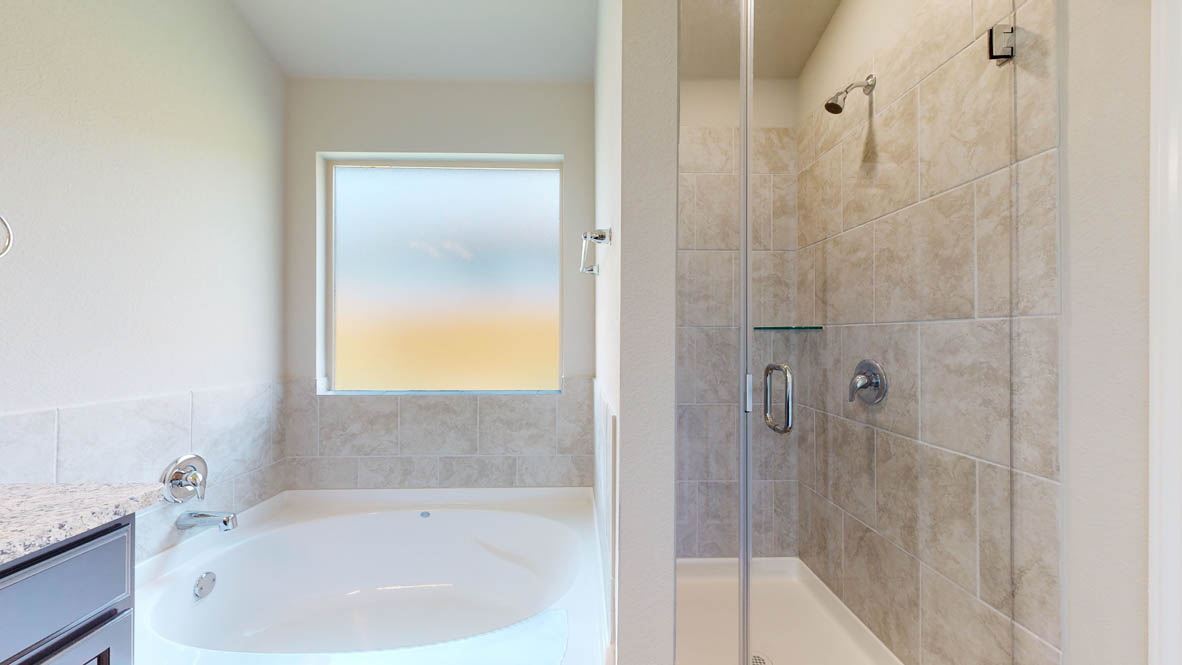 405 Creekfall Road Burnet, TX 78611 - Photo 15 of 27 Full bathroom with vanity, a shower stall, and a garden tub