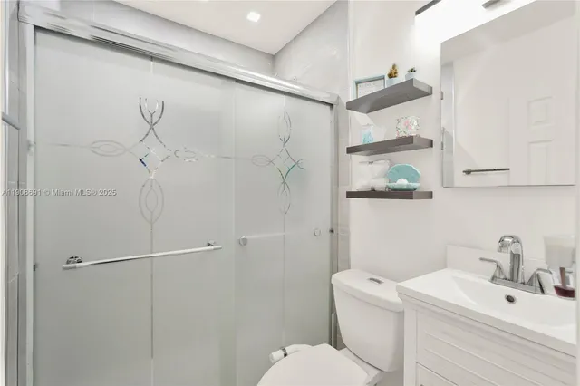 a bathroom with a toilet sink and shower