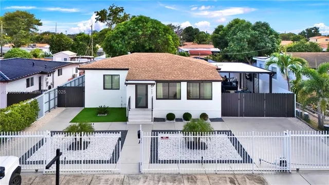 a view of a house with backyard porch and sitting area