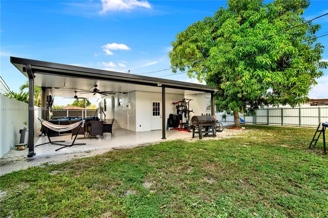a view of a house with backyard porch and sitting area