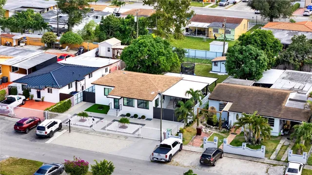 a view of a patio with table and chairs and potted plants
