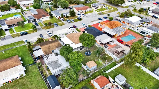 an aerial view of residential houses with outdoor space
