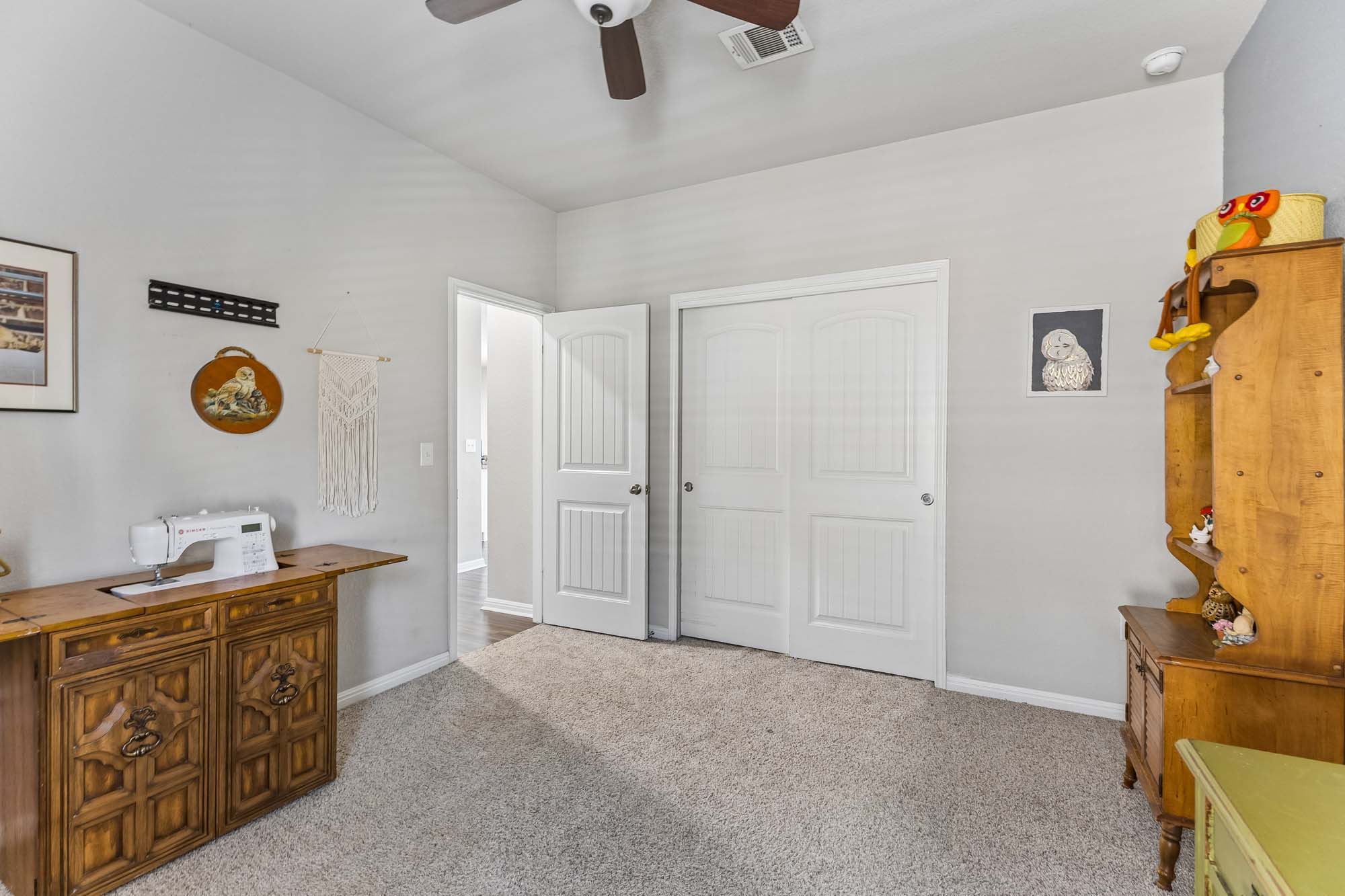 124 Moravia Road Georgetown, TX 78626 - Photo 27 of 38 High ceilings and neutral tones create an open feel in this versatile carpeted bedroom.