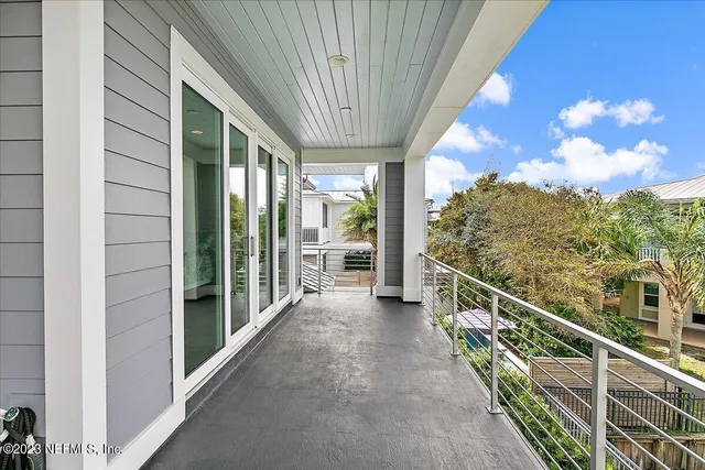 a bathroom with a granite countertop sink mirror vanity bathtub and next to a window