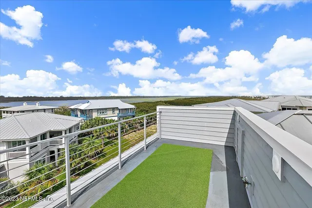 a kitchen with a sink stove and wooden floor