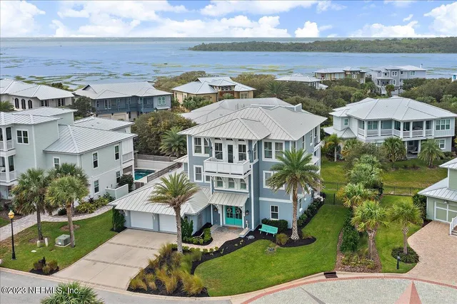 a front view of residential houses with yard and green space
