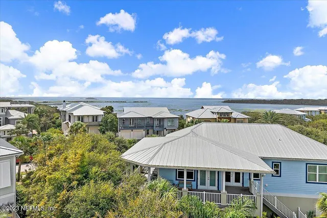 a kitchen with kitchen island a white counter top space and living room view