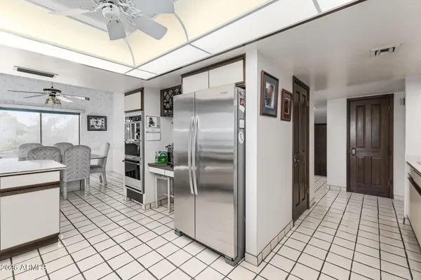 a view of a livingroom with workspace and a window