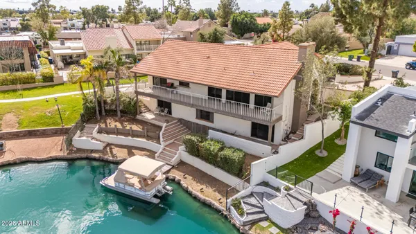 an aerial view of a house with a garden and swimming pool
