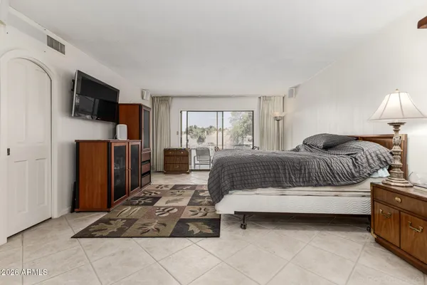 a bedroom with a bed and a table