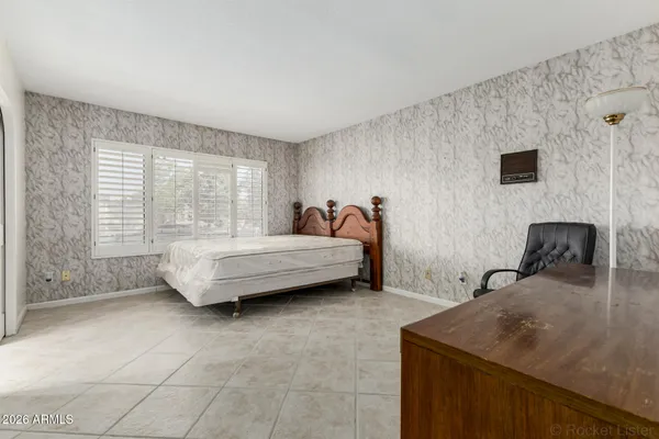 a bedroom with a bed and a window