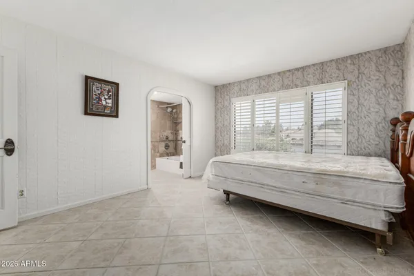 a bedroom with a bed and a book shelf