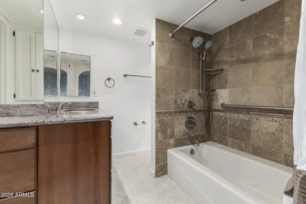 a bathroom with a granite countertop sink a toilet and a mirror