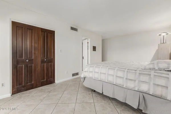 a bathroom with a granite countertop sink a toilet and a mirror