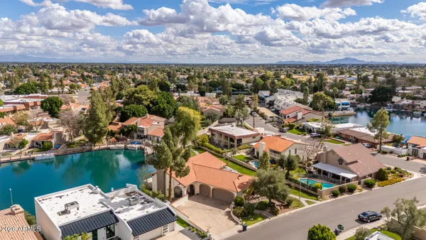 an aerial view of a house with swimming pool garden and patio