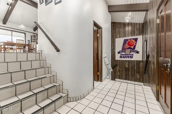 a living room with furniture a flat screen tv and a floor to ceiling window