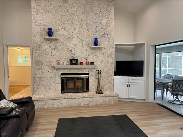 a living room with a fireplace and a flat screen tv