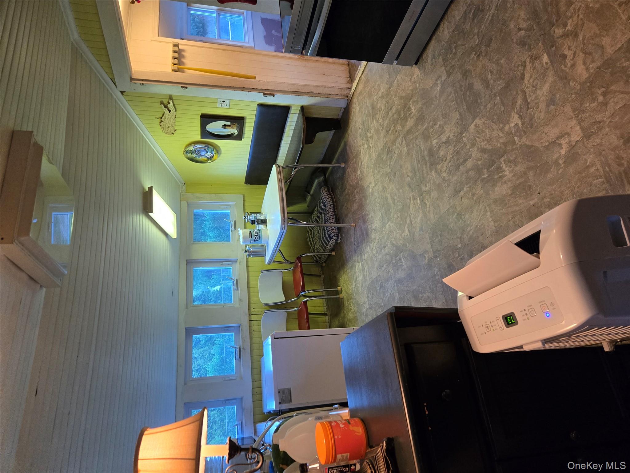 3953 Sound Avenue Riverhead, NY 11901 - Photo 11 of 14 a living room with furniture a window and a flat screen tv