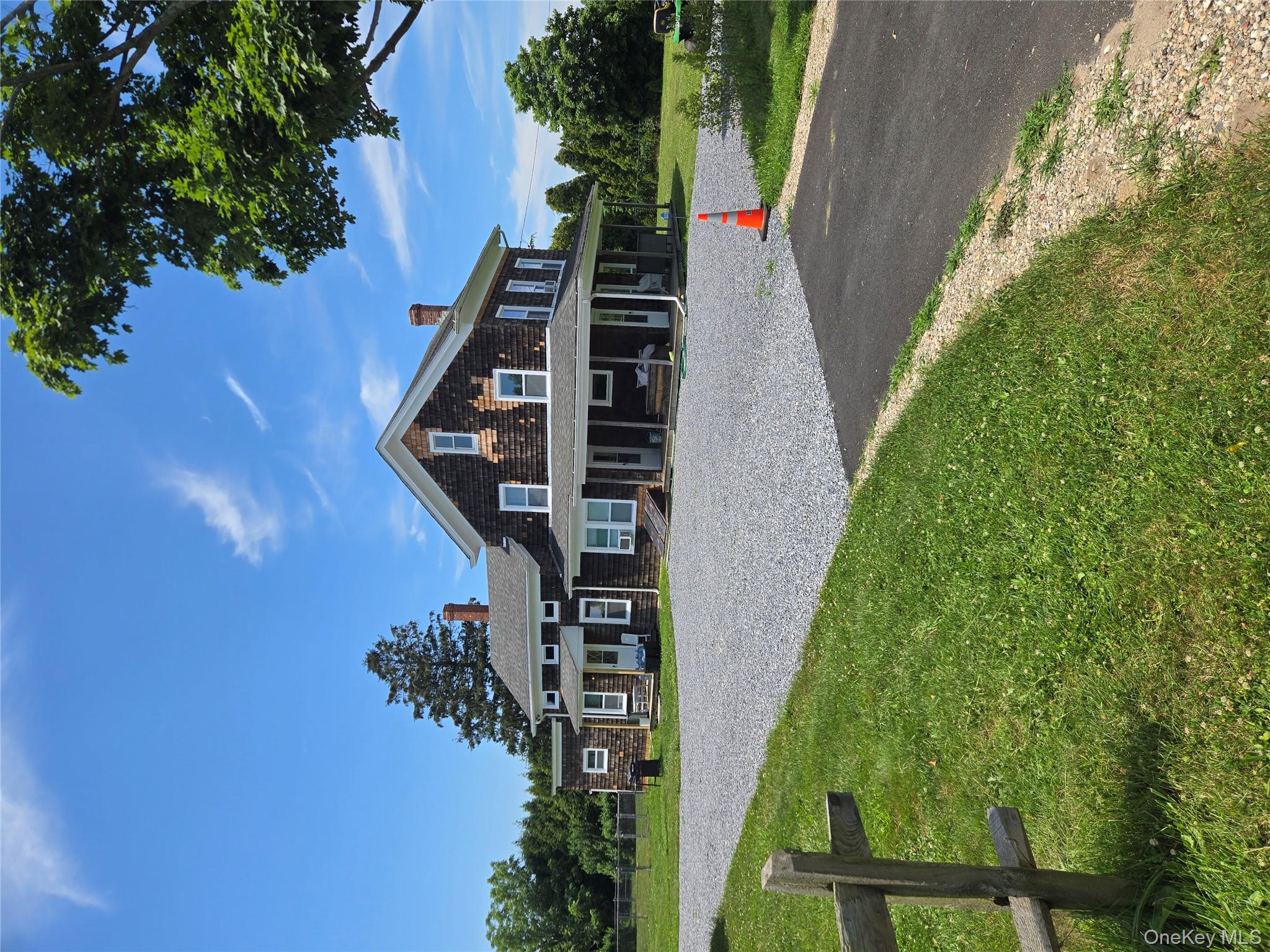 3953 Sound Avenue Riverhead, NY 11901 - Photo 2 of 14 a front view of a house with a yard