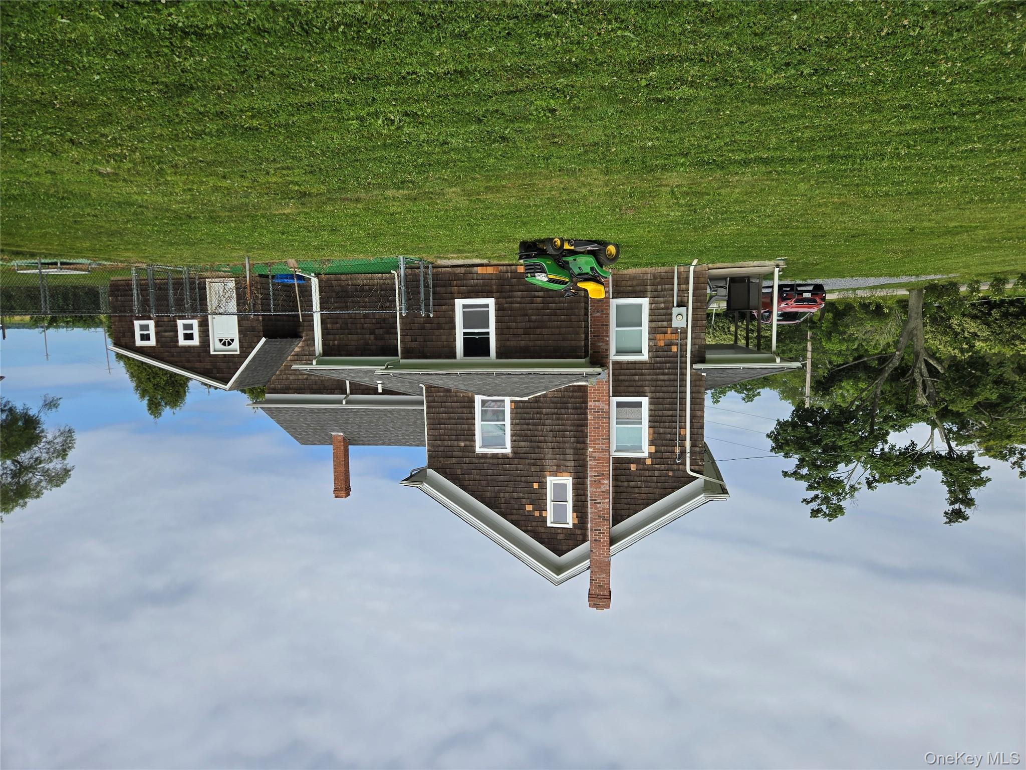 3953 Sound Avenue Riverhead, NY 11901 - Photo 3 of 14 a front view of a house with garden