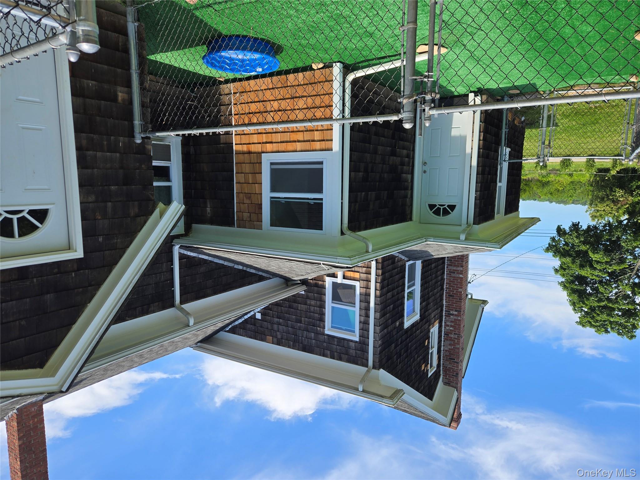 3953 Sound Avenue Riverhead, NY 11901 - Photo 7 of 14 a front view of a house with yard