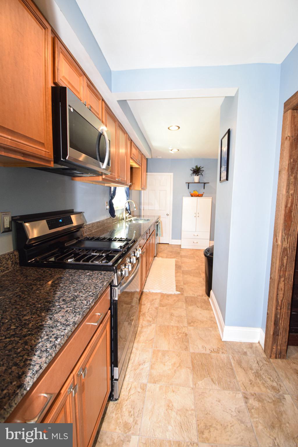 149 Post Road Aberdeen, MD 21001 - Photo 15 of 49 a kitchen with stainless steel appliances granite countertop a stove and a microwave