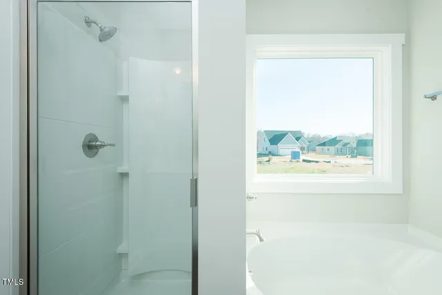 a bathroom with a bathtub and shower
