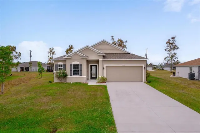 a front view of a house with a yard and garage