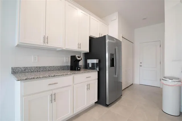 a kitchen with stainless steel appliances granite countertop a refrigerator and a stove