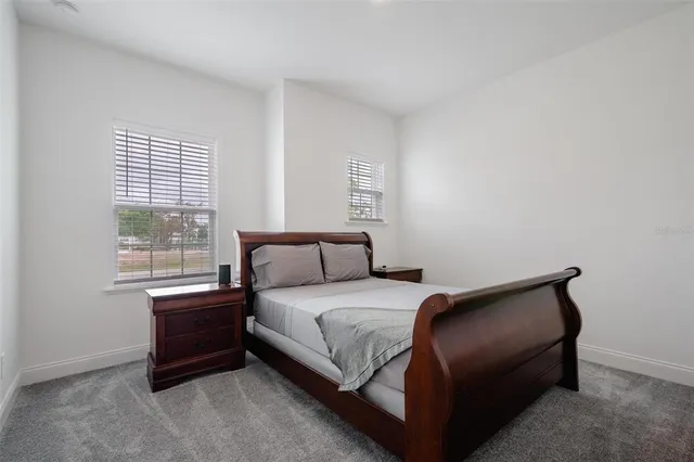 a bedroom with a bed and window