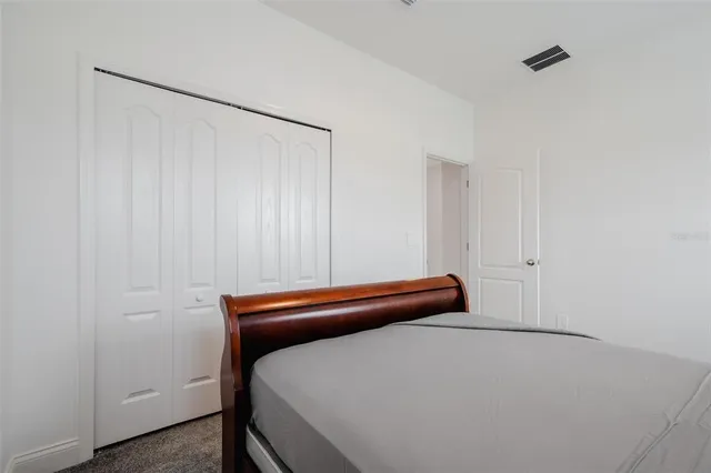 a room with a bed and cabinets