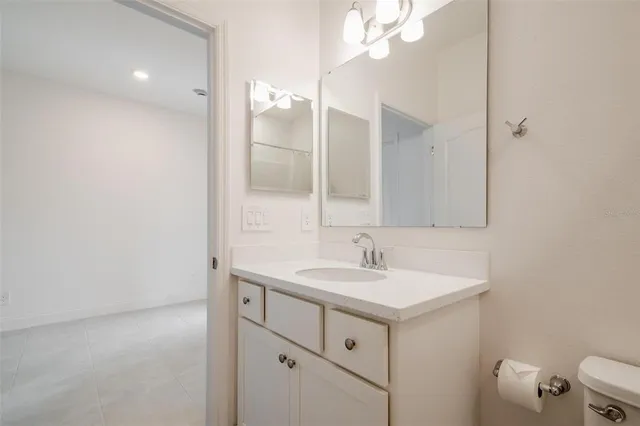 a bathroom with a sink vanity and a mirror
