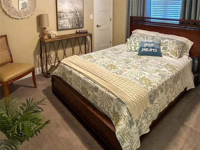 a large bed sitting in a bedroom next to a window