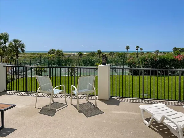 a view of a chair and tables front of the house
