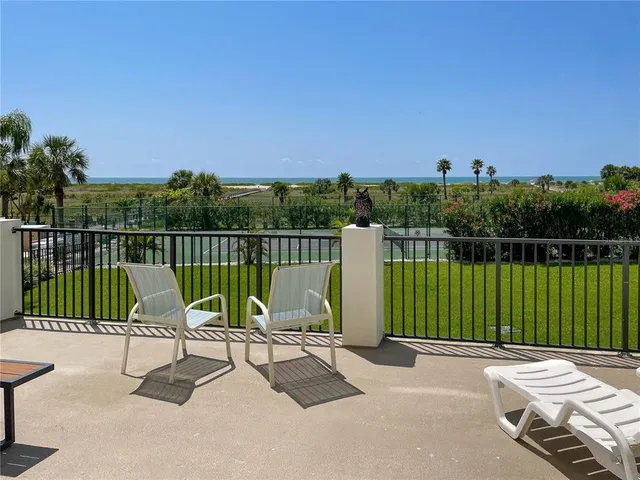 a view of a chair and tables front of the house