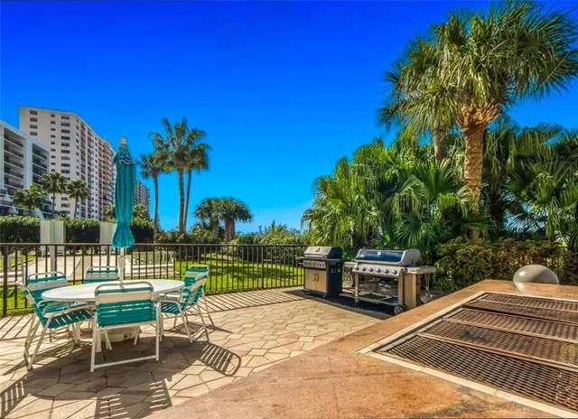 a view of a patio with a table and chairs