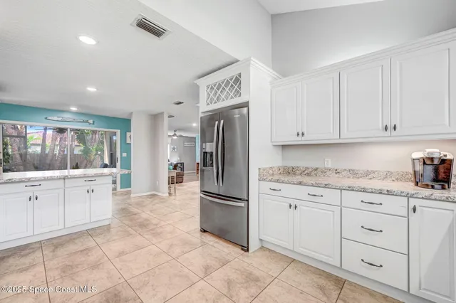a bedroom with two beds and a large window