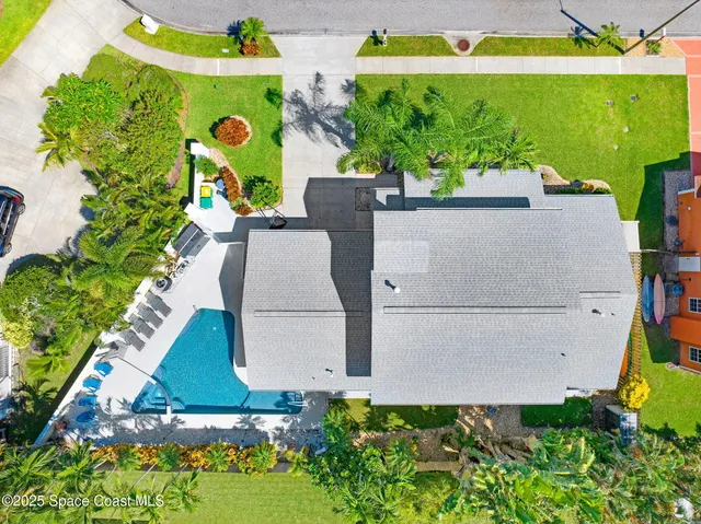an aerial view of a house with a yard and garden