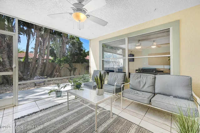 a view of a backyard with plants and outdoor seating
