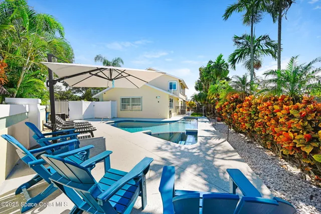 a view of a swimming pool with outdoor seating