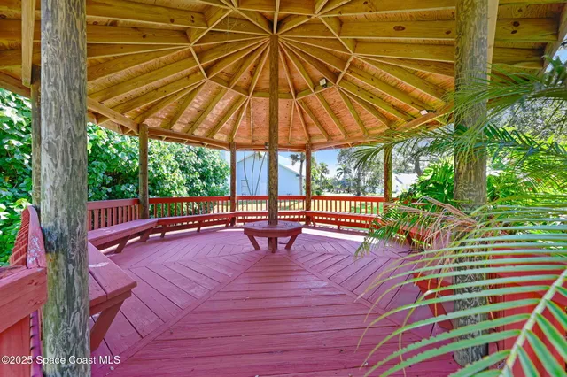 a front view of a house with a garden and plants