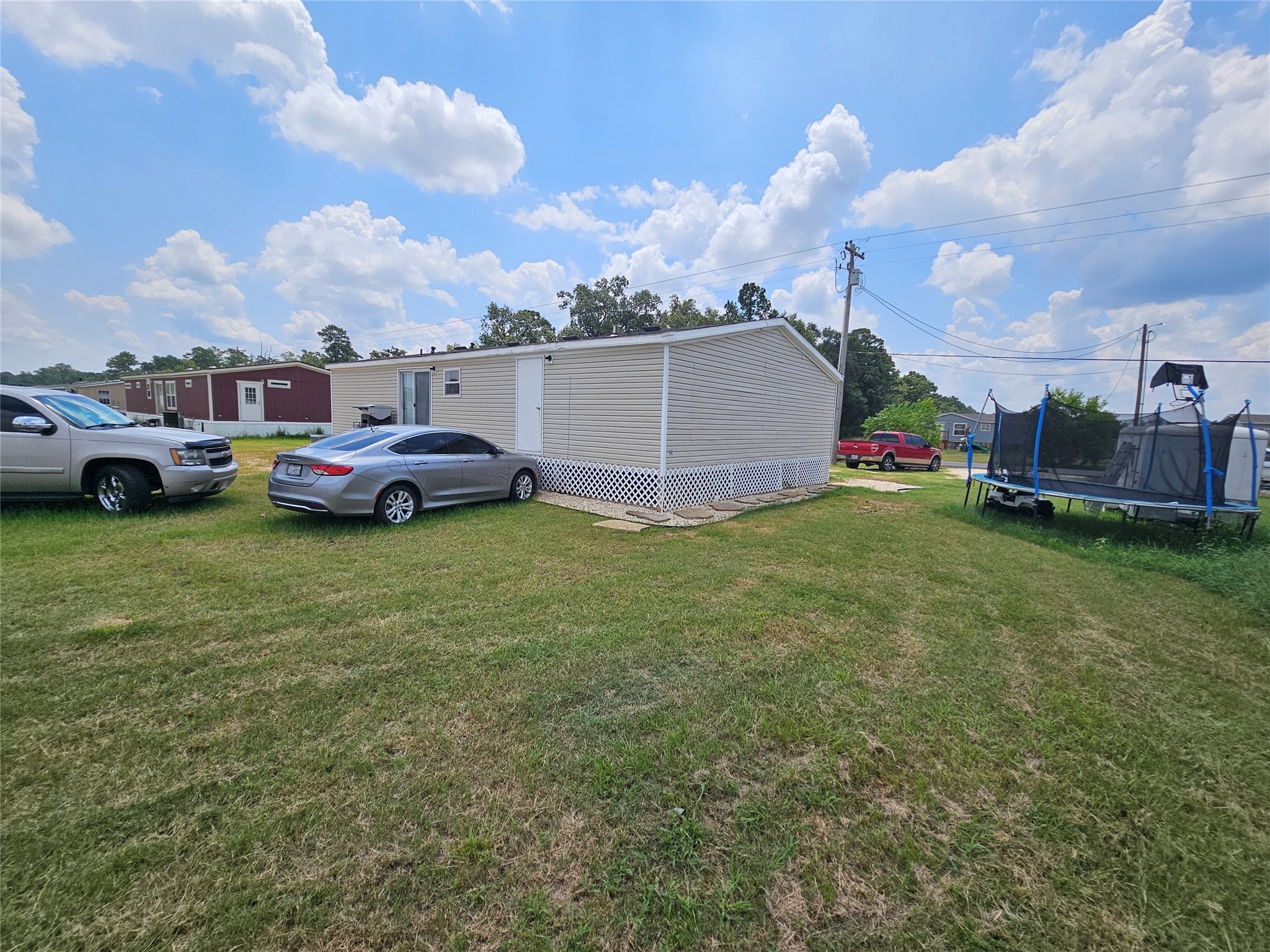 15519 Schank Road Conroe, TX 77306 - Photo 5 of 15 a front view of a house with a garden and parking space